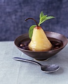 Poached pear in syrup with raisins