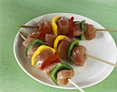 Three turkey kebabs with peppers