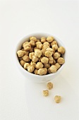Chick-peas in and in front of a small bowl