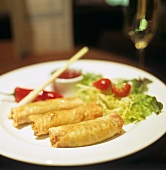 Three small spring rolls on a plate