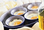 Eggs in moulds in bain-marie (making Eggs Florentine)