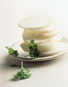 Slices of white radish in a pile