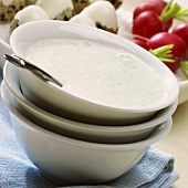 Frothy salad dressing in a small bowl
