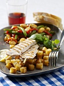 Chicken kebab with diced potatoes and bean salad
