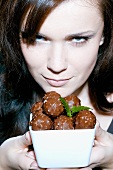 Young woman with bowl of chocolates