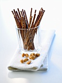 Salted sticks in a glass and a few peanuts