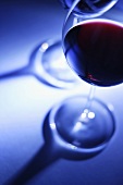 A glass of red wine against a blue background