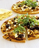 Pizza with goat's cheese, onions and olives