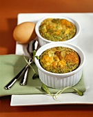 Egg soufflés with herbs in soufflé dishes