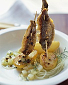 Steckerlfisch (grilled fish on sticks) with potato & cucumber