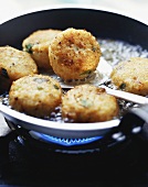 Fish cakes in a frying pan