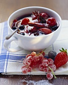 Red berry compote with vanilla cream in a cup