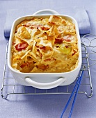 Pasta bake with white cabbage and ham in baking dish