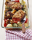 Fried entrecôte steaks with onion crust on roasted vegetables