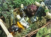 Basket of herbs with bottles of oil and vinegar