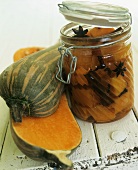 A fresh squash beside pickled squash in preserving jar