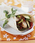 Tortilla filled with chicken, avocado and peppers