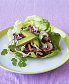 Mixed raw vegetable salad on a lettuce leaf