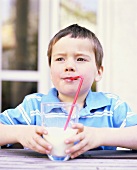 A Little Boy Drinking a Glass of Milk