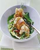 Monkfish skewered on rosemary on salad