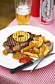 Grilled beef steak with spicy sauce and potatoes
