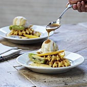 Waffles with fruit, vanilla ice cream and caramel sauce