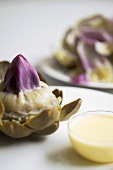 Cooked artichoke with hollandaise sauce