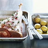 Leg of lamb studded with rosemary, and potatoes
