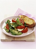 Salad of avocado, tomatoes and young spinach