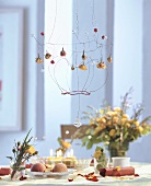 Wire wreath with flowers over laid table