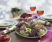 Laid table with lilac wreath
