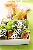 Soft cheese balls rolled in sesame seeds with figs & toast