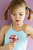 Small girl eating Amarena cherry ice cream