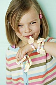 A little girl eating a candy watch