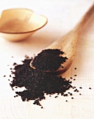 Black cumin with wooden spoon
