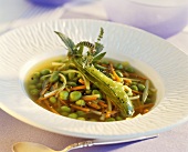 Pea soup with julienne vegetables and mint