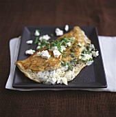 Omelette filled with herbs and sheep's cheese