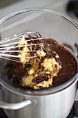 Mixing chocolate ice cream mixture in bain-marie