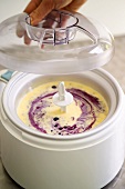 Making blueberry ice cream in an ice cream maker