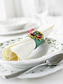 A place-setting with napkin and napkin ring