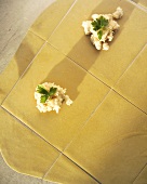 Making ravioli, putting filling onto pasta squares