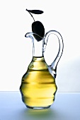 Carafe of olive oil with olive