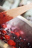 Berry jam, stirring the fruit and sugar