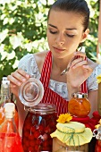 Woman tasting bottled fruit