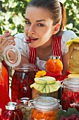 Woman tasting bottled fruit