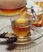 Black tea with sugar crystals and biscuit
