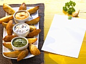 Oven-baked potato wedges with three dips
