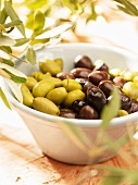 Green and black olives in a small bowl