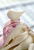 A clove of garlic on a garlic bulb