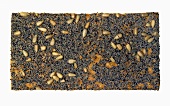 A slice of crispbread with poppy seeds and sunflower seeds